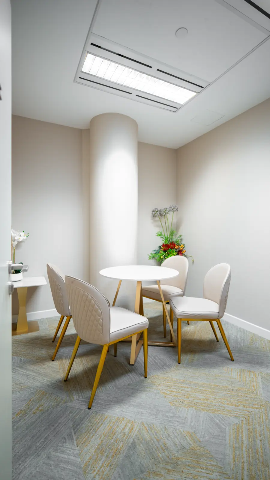 Private consultation room with a round table and chairs at Fusion Medical