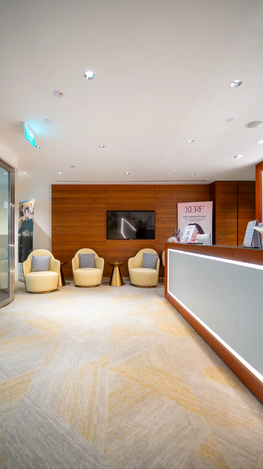 Armchairs in the waiting lounge beside the reception desk at Fusion Medical
