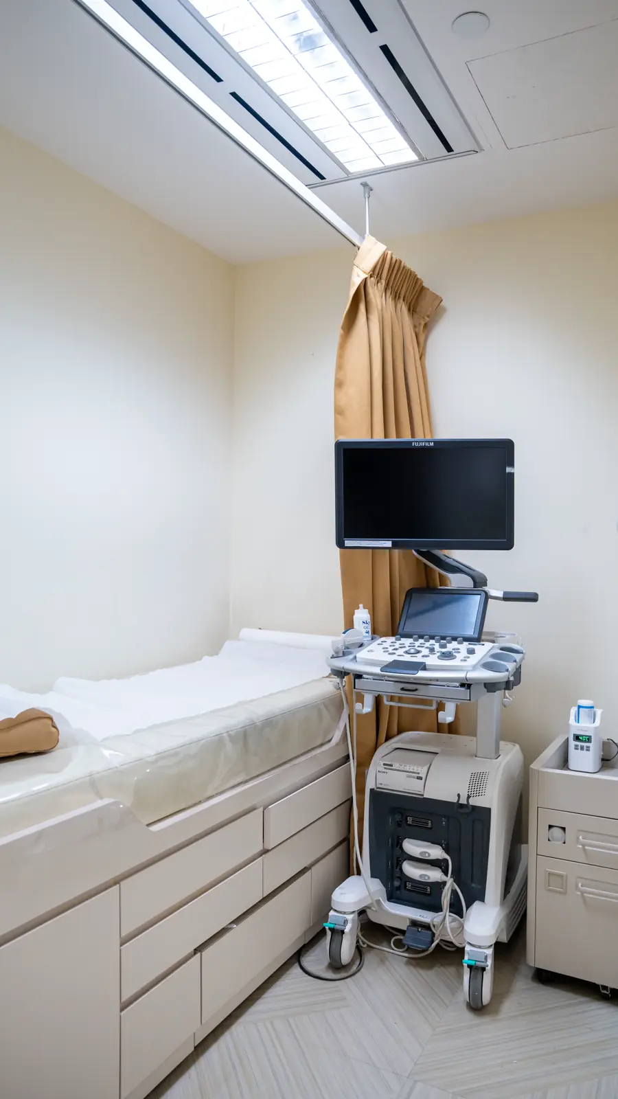 Ultrasound room at Fusion Medical, with an examination couch and ultrasound machine