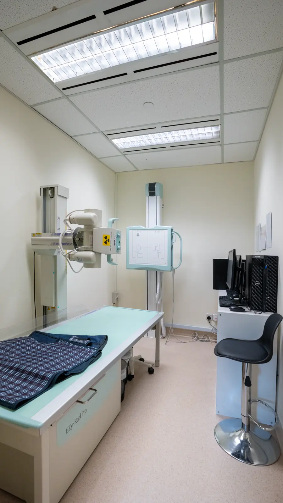 X-ray room at Fusion Medical, with the X-ray table, upright chest stand and workstation