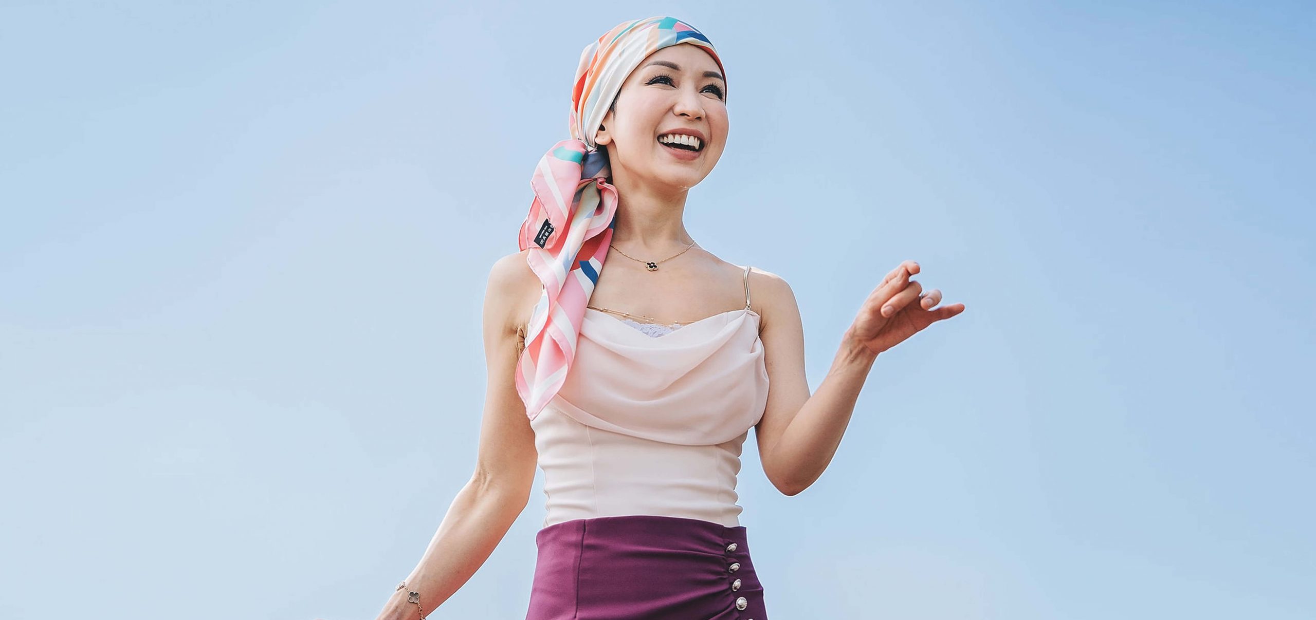 Woman wearing a headscarf against a blue background