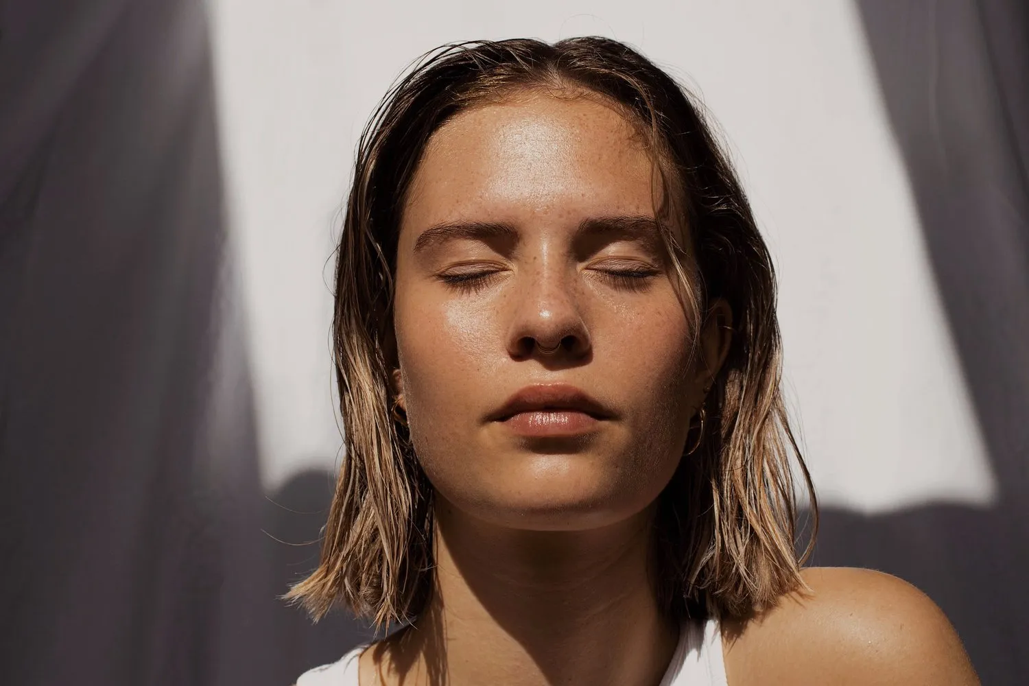 Woman resting in warm sunlight with her eyes closed