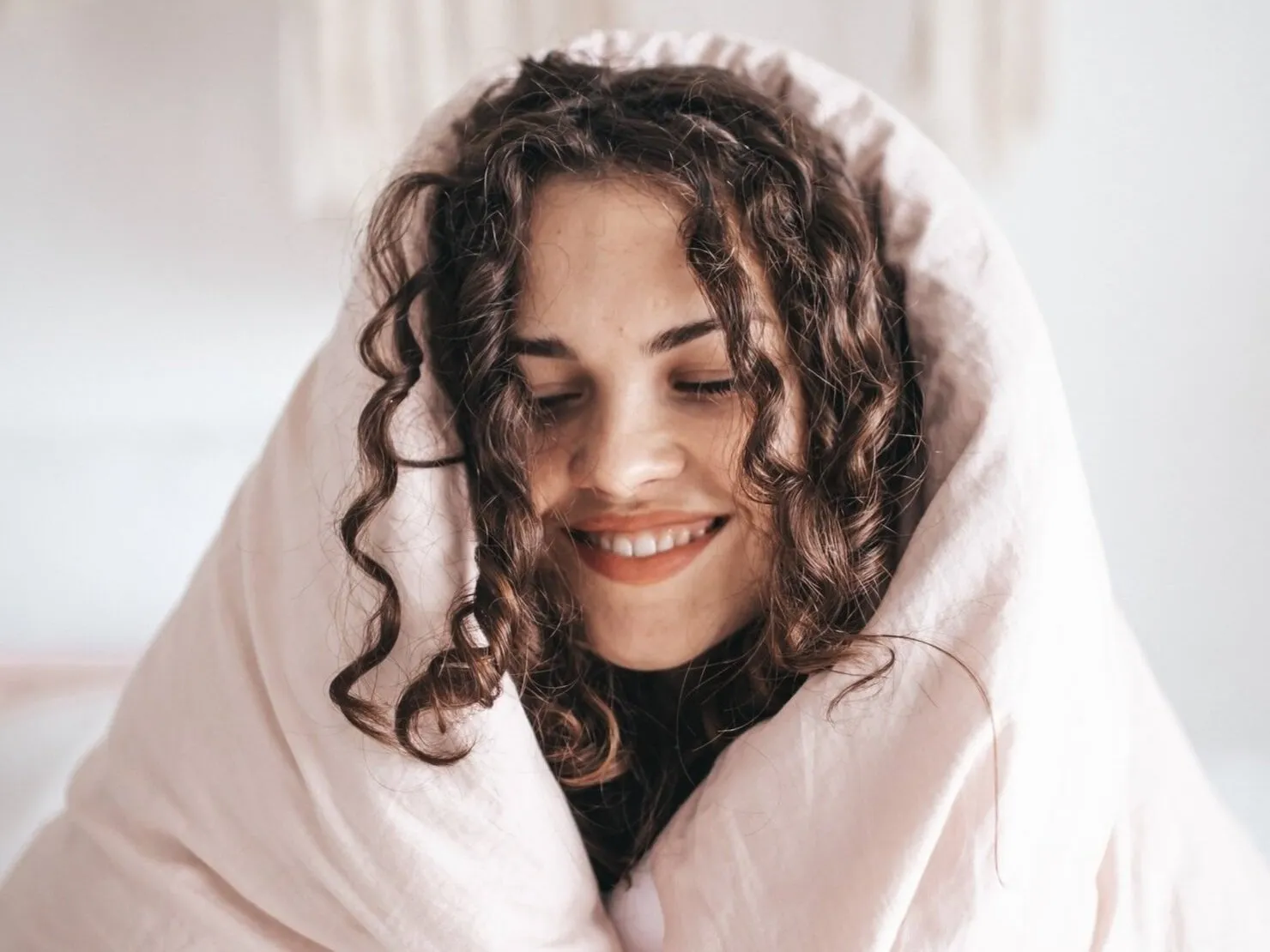 Woman wrapped in a blanket and smiling